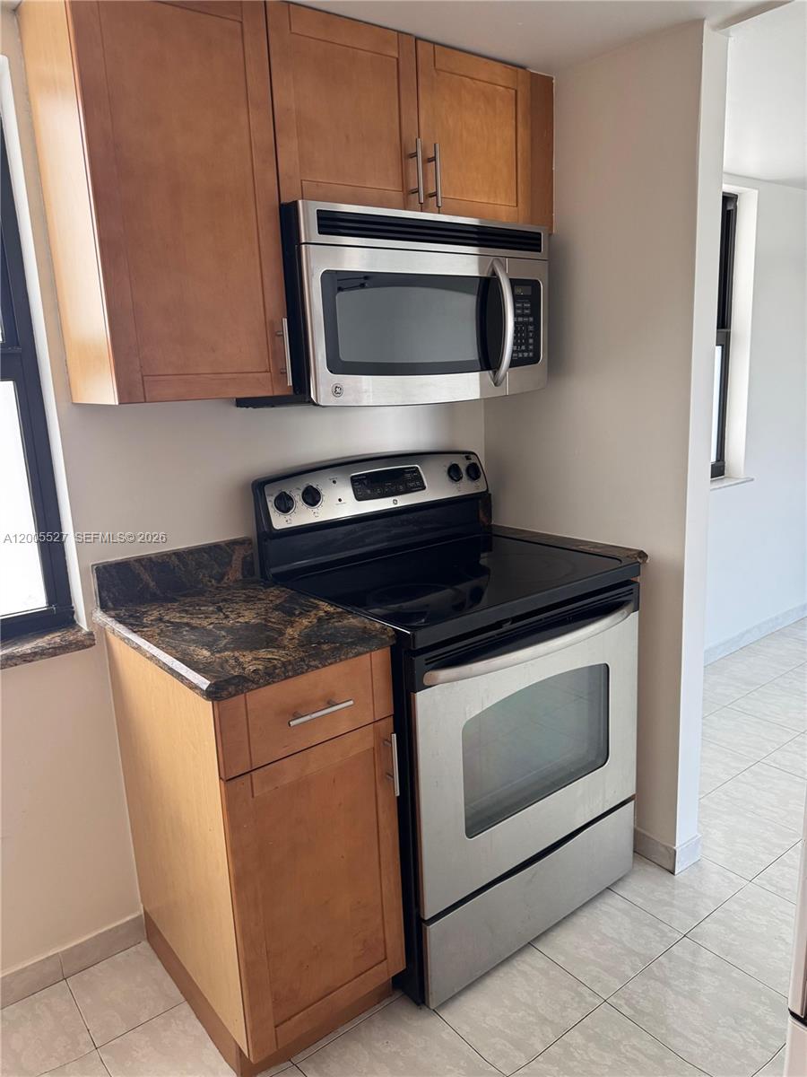 6725 Harding Avenue, Unit 503 Miami Beach, FL 33141 - Photo 13 of 23 a stove top oven sitting inside of a kitchen