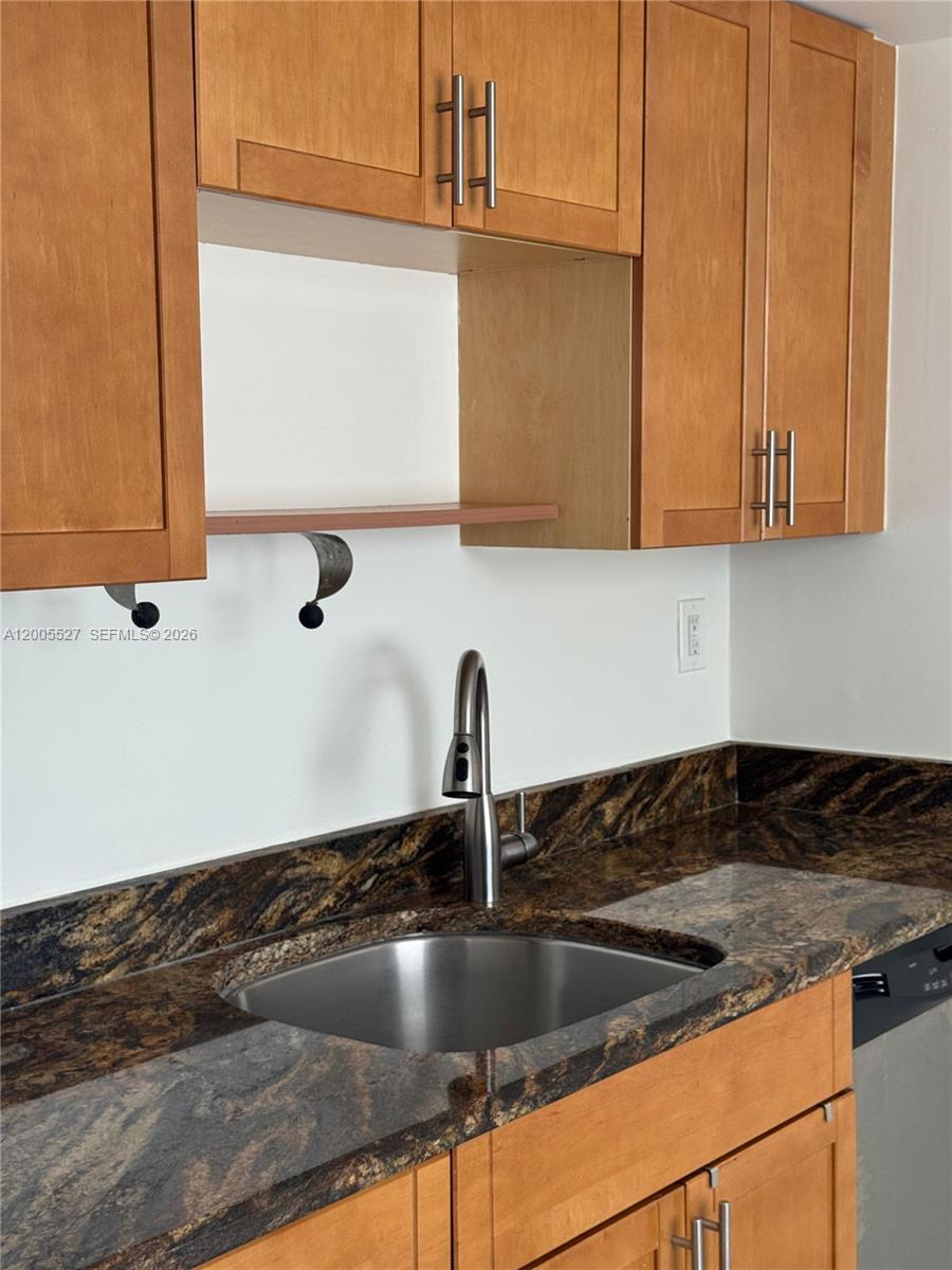 6725 Harding Avenue, Unit 503 Miami Beach, FL 33141 - Photo 14 of 23 a kitchen with granite countertop a sink and a stove