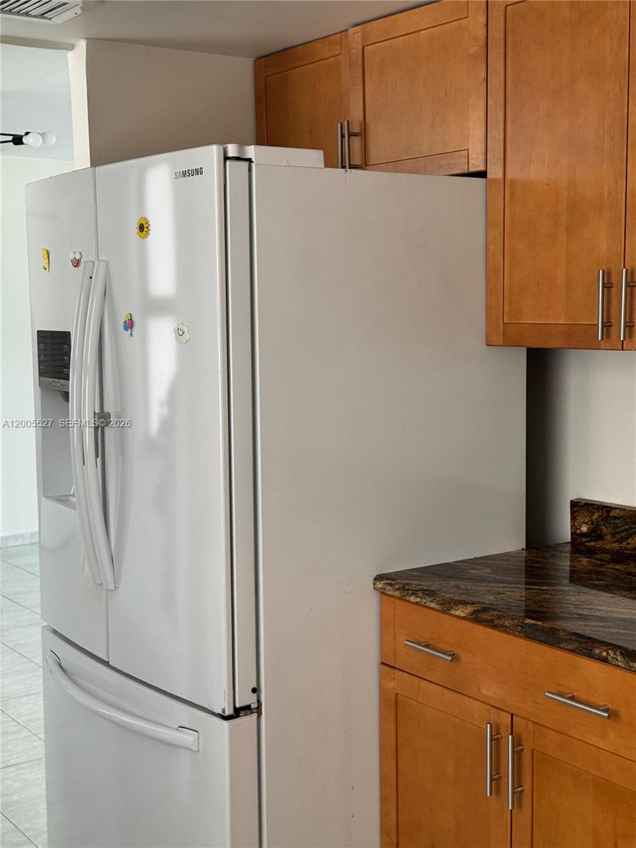 6725 Harding Avenue, Unit 503 Miami Beach, FL 33141 - Photo 15 of 23 a white refrigerator freezer sitting in a kitchen