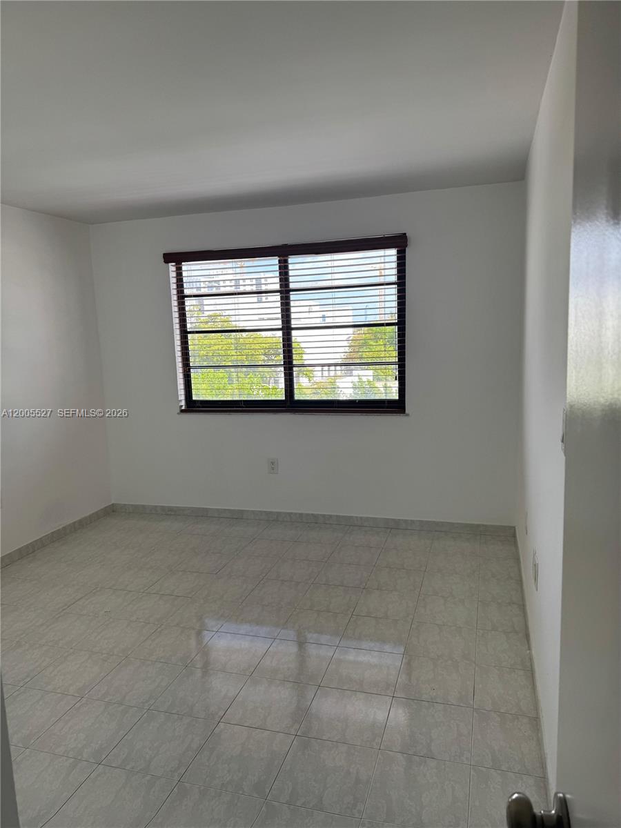 6725 Harding Avenue, Unit 503 Miami Beach, FL 33141 - Photo 4 of 23 an empty room with windows