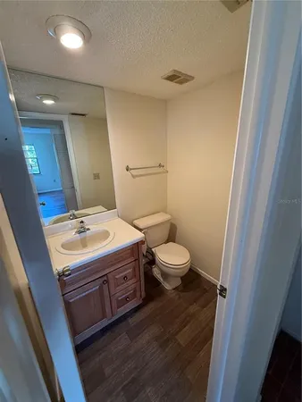 a bathroom with a sink a toilet and mirror