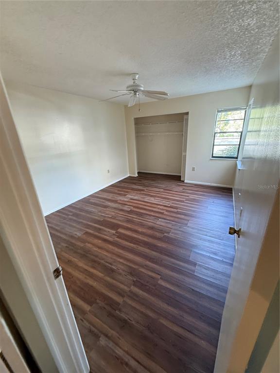 8013 Picketts Court, Unit 1 Spring Hill, FL 34613 - Photo 13 of 15 wooden floor in an empty room with a window