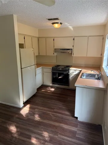 a kitchen with a refrigerator and a stove
