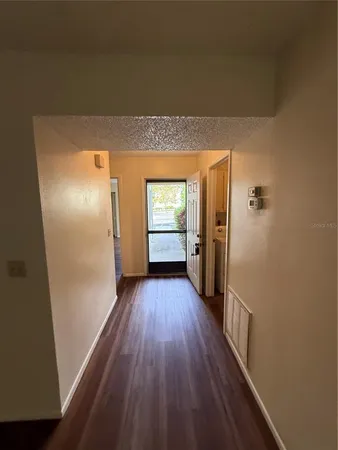 a view of hallway with wooden floor