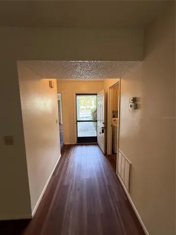 a view of hallway with wooden floor