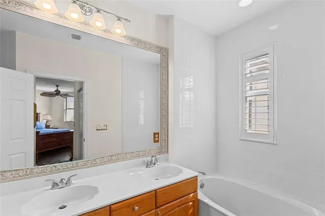 a bathroom with a granite countertop toilet sink and mirror