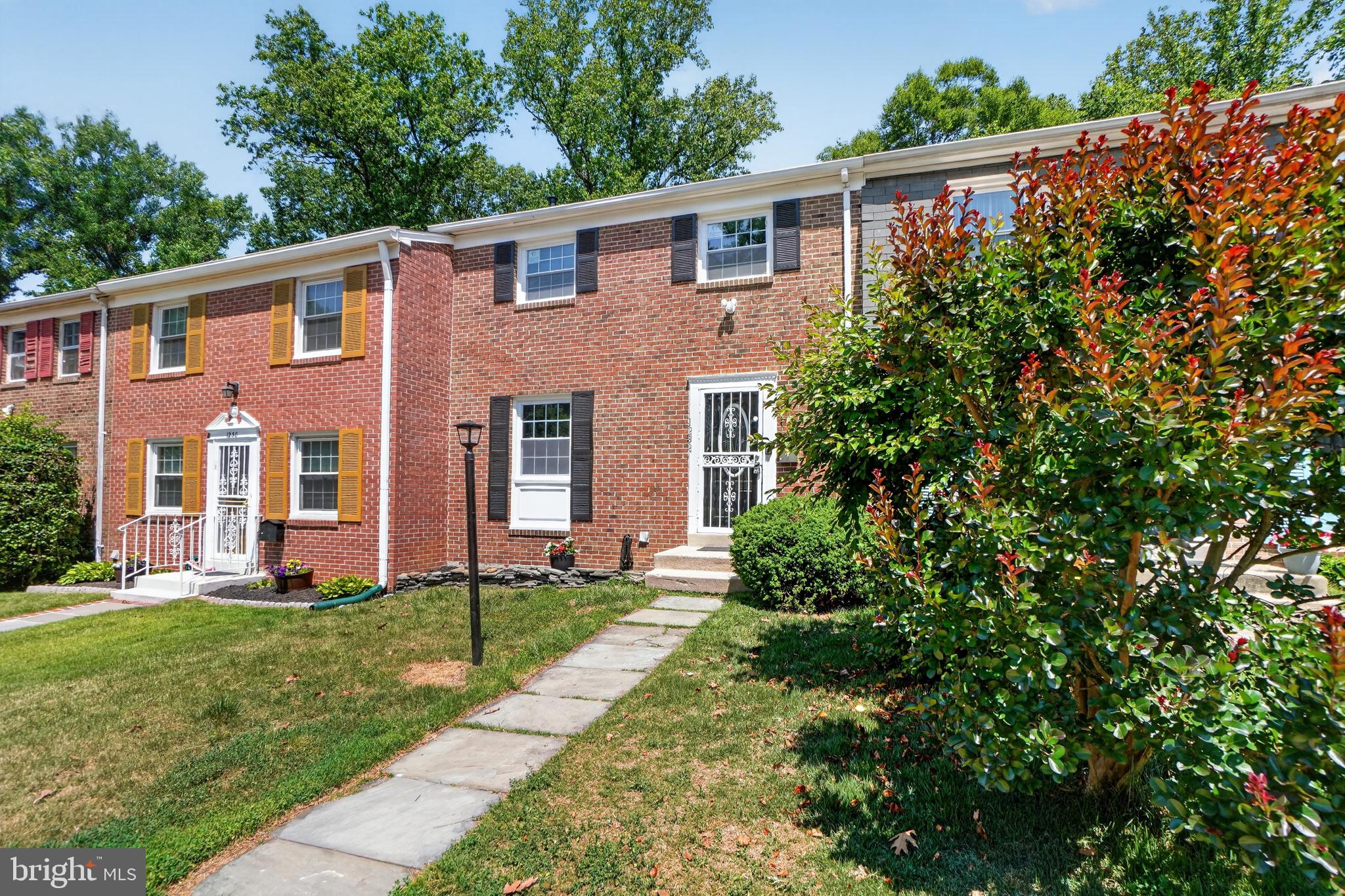 1232 Palmer Road, Unit 111 Fort Washington, MD 20744 - Photo 4 of 45 a front view of a house with a yard
