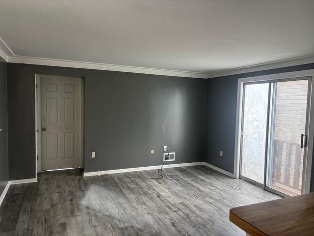 1222 Broadway Avenue, Unit 2 East McKeesport, PA 15035 - Photo 4 of 10 an empty room with wooden floor and windows
