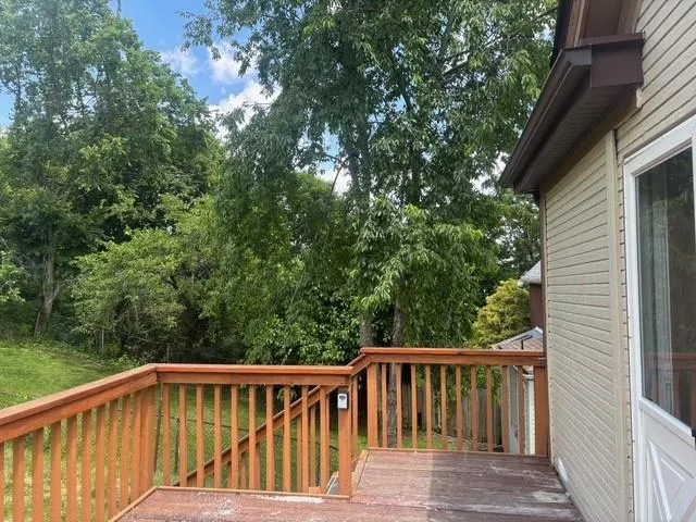 a view of balcony with deck and trees