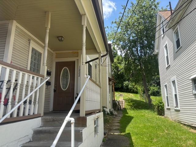 1222 Broadway Avenue, Unit 2 East McKeesport, PA 15035 - Photo 10 of 10 a view of a house with a small yard