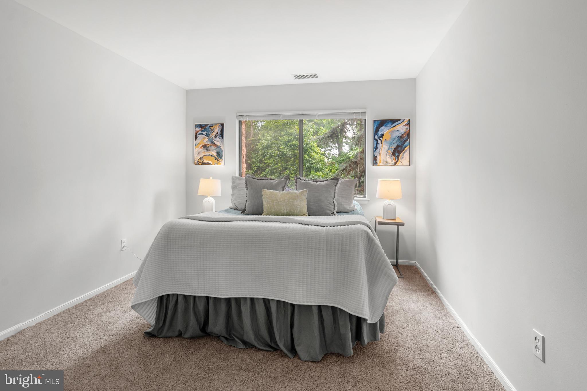 2901 Fallstaff Road, Unit 305 Baltimore, MD 21209 - Photo 11 of 13 a bed sitting in a bedroom next to a window