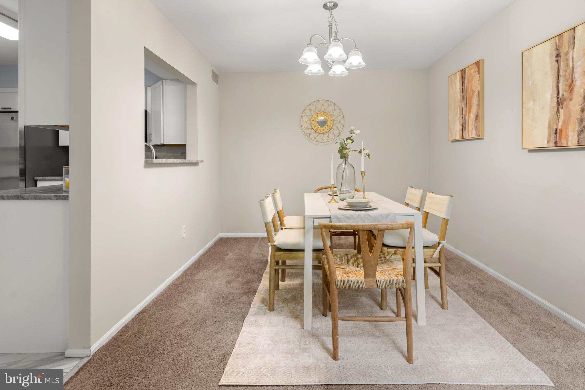 2901 Fallstaff Road, Unit 305 Baltimore, MD 21209 - Photo 6 of 13 a view of a dining room with furniture and chandelier