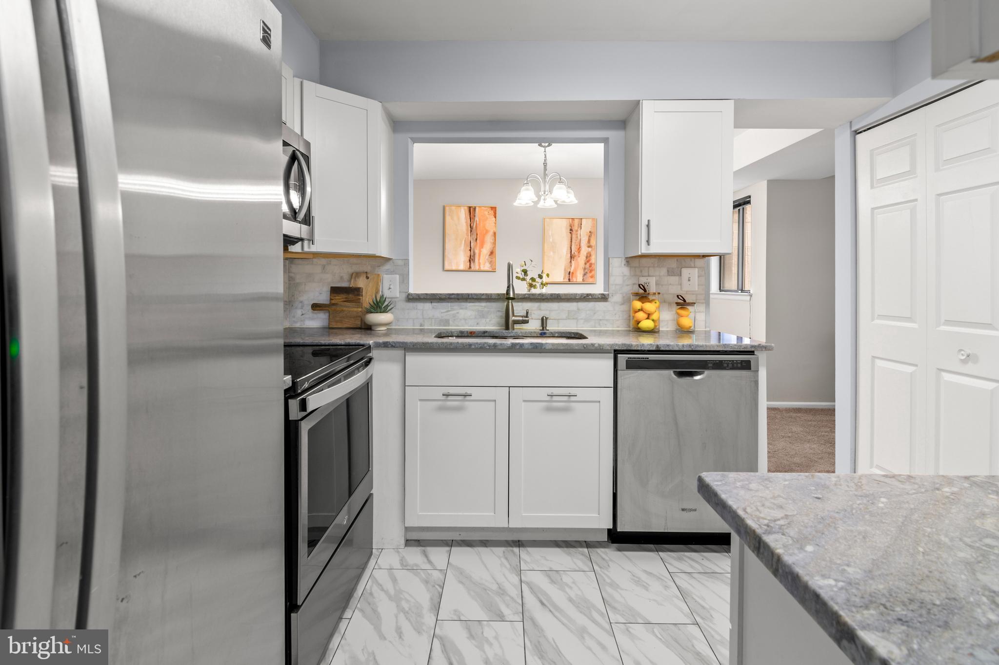 2901 Fallstaff Road, Unit 305 Baltimore, MD 21209 - Photo 7 of 13 a kitchen with a sink stove and cabinets