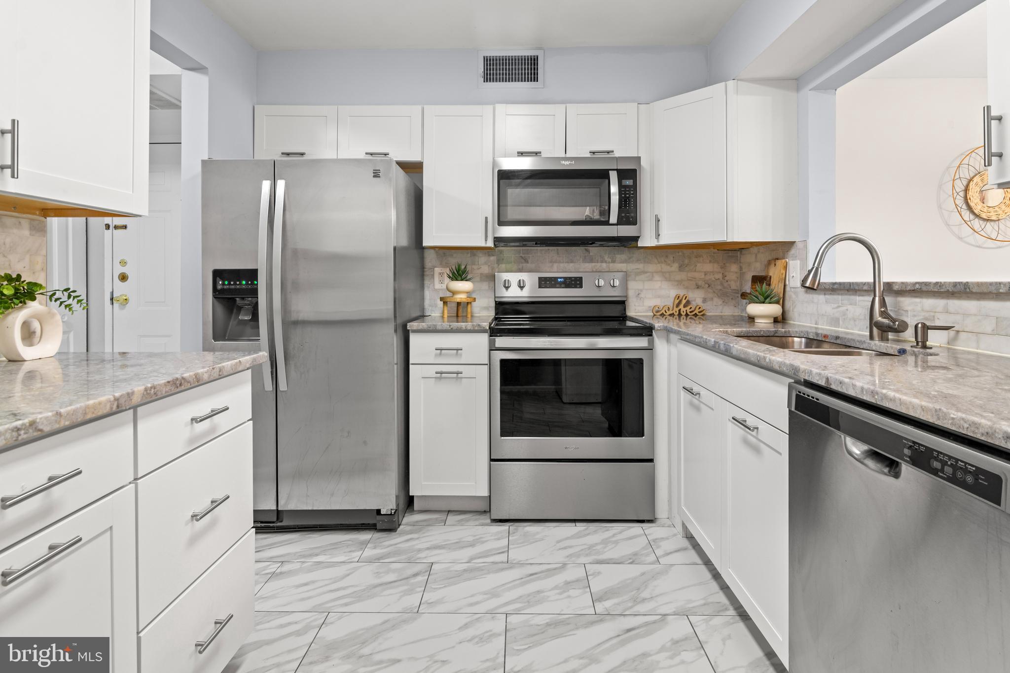 2901 Fallstaff Road, Unit 305 Baltimore, MD 21209 - Photo 8 of 13 a kitchen with stainless steel appliances granite countertop a stove a sink and a refrigerator