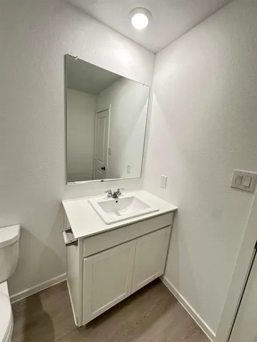 a utility room with a sink and mirror