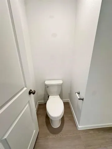 a white toilet sitting next to a white sink