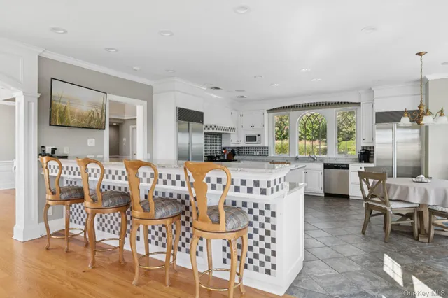 a living room with furniture a flat screen tv and a table