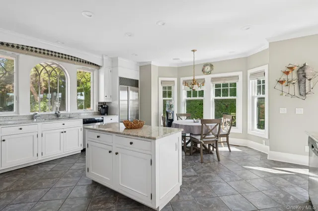 a view of a large kitchen with furniture and window