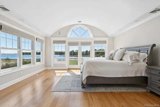 a spacious bedroom with a bed and a large window with outer view