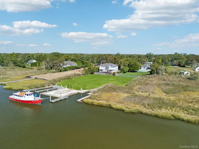 a view of a lake with houses in the back