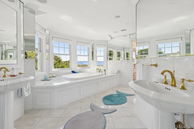 a large kitchen with a sink and living room view