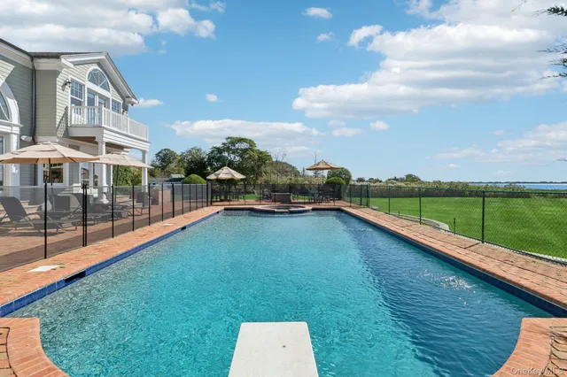 a view of a patio with a dining table and chairs under an umbrella