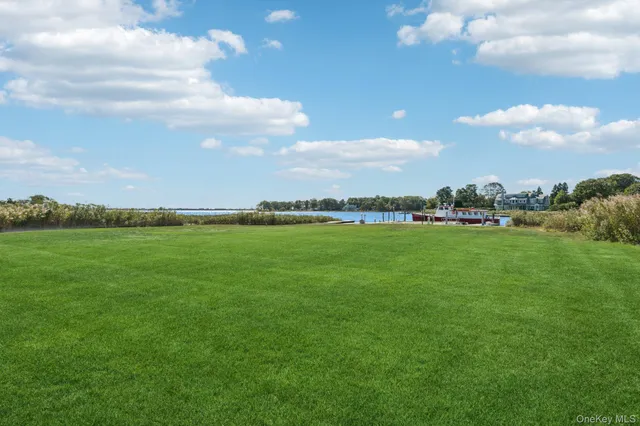 an aerial view of a house with outdoor space and lake view