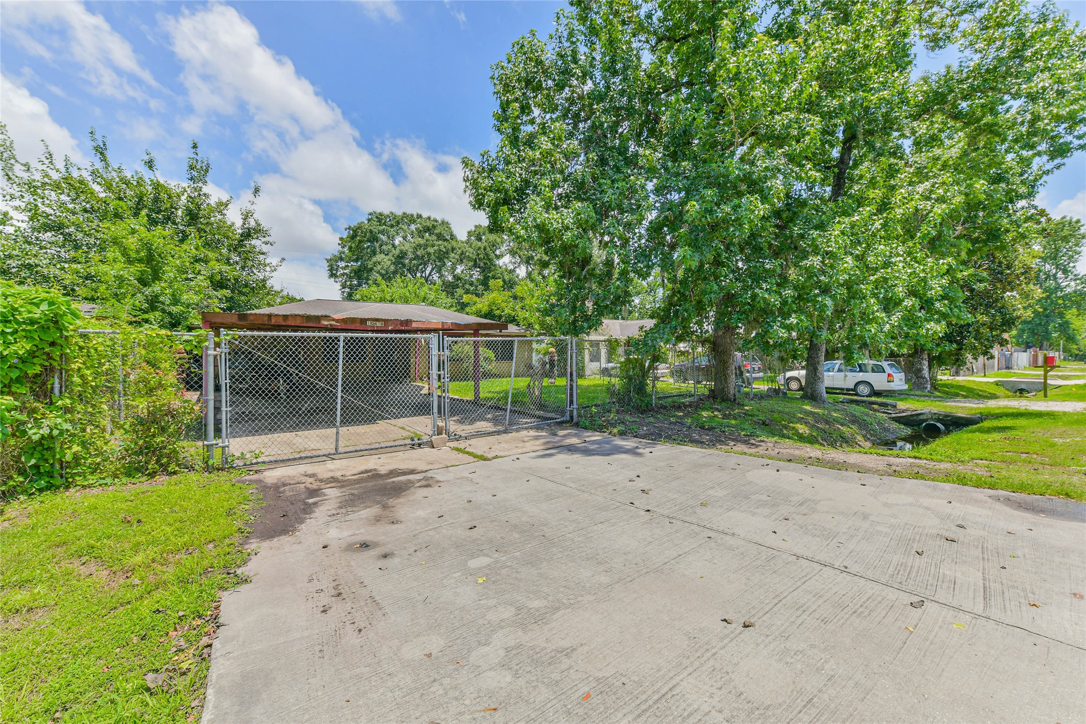 10438 Caxton Street Houston, TX 77016 - Photo 4 of 24 a view of a yard with potted plants and trees
