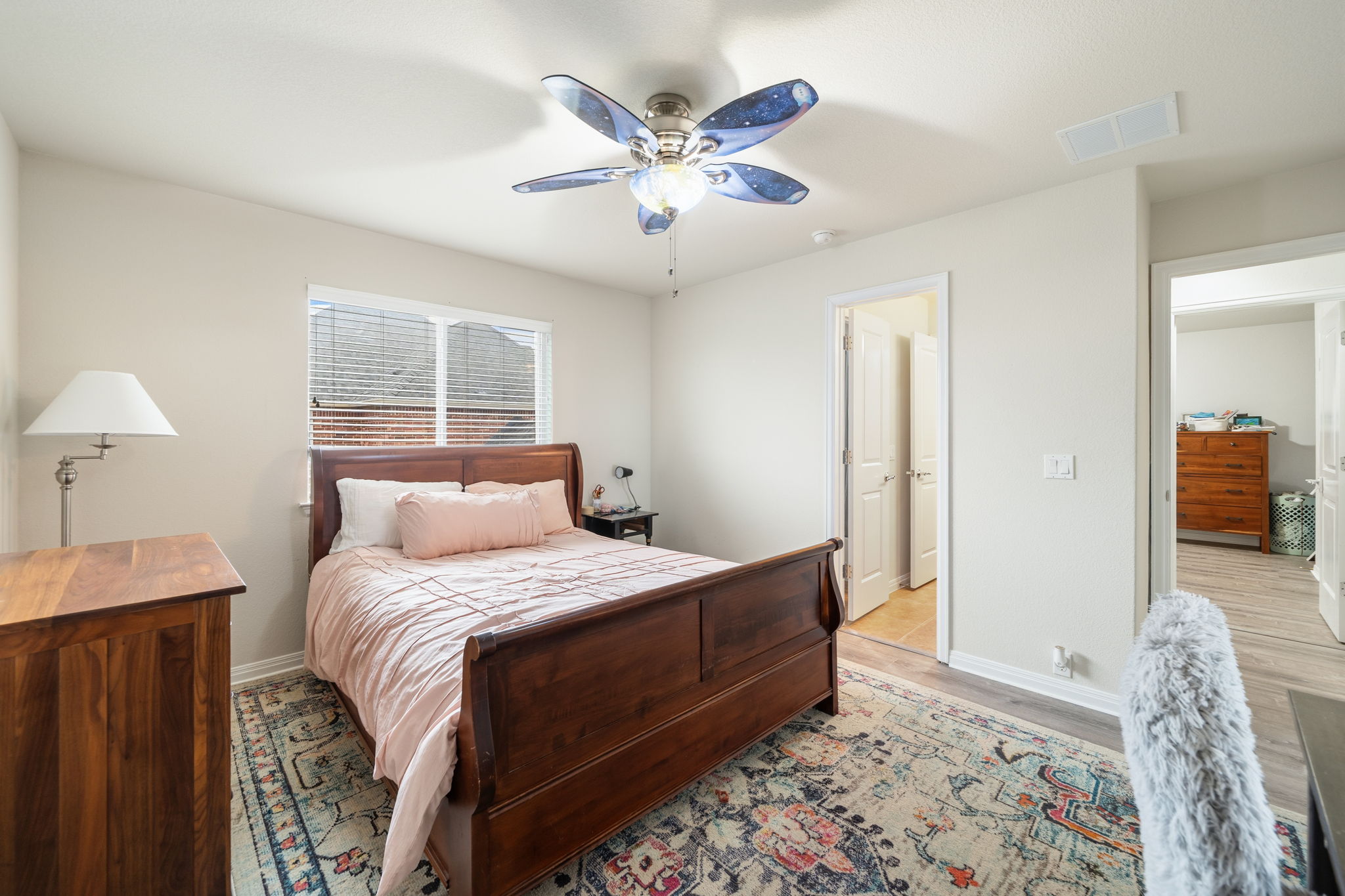 1581 Grassy Field Road Austin, TX 78737 - Photo 28 of 37 A spacious bedroom offers durable wood flooring and neutral walls under a classic smooth ceiling.