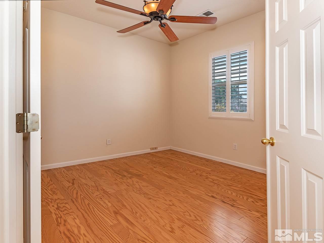 10440 Silver Rush Court Reno, NV 89521 - Photo 12 of 22 an empty room with windows and fan