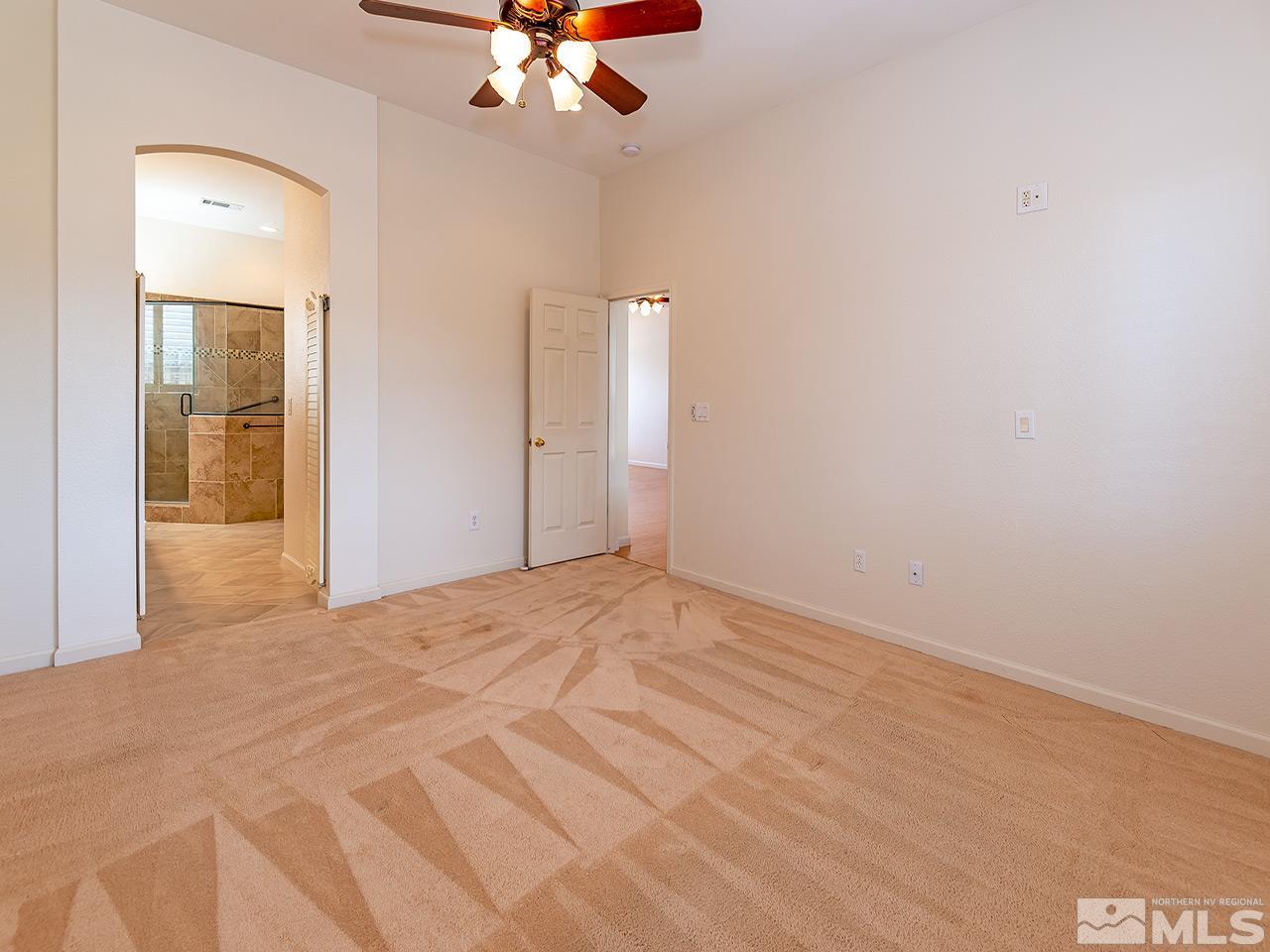 10440 Silver Rush Court Reno, NV 89521 - Photo 14 of 22 a view of an empty room with a chandelier fan