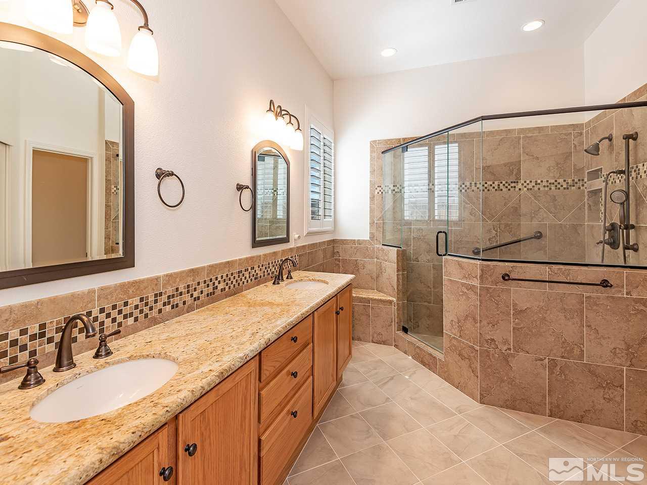 10440 Silver Rush Court Reno, NV 89521 - Photo 15 of 22 a spacious bathroom with a double vanity sink and a mirror