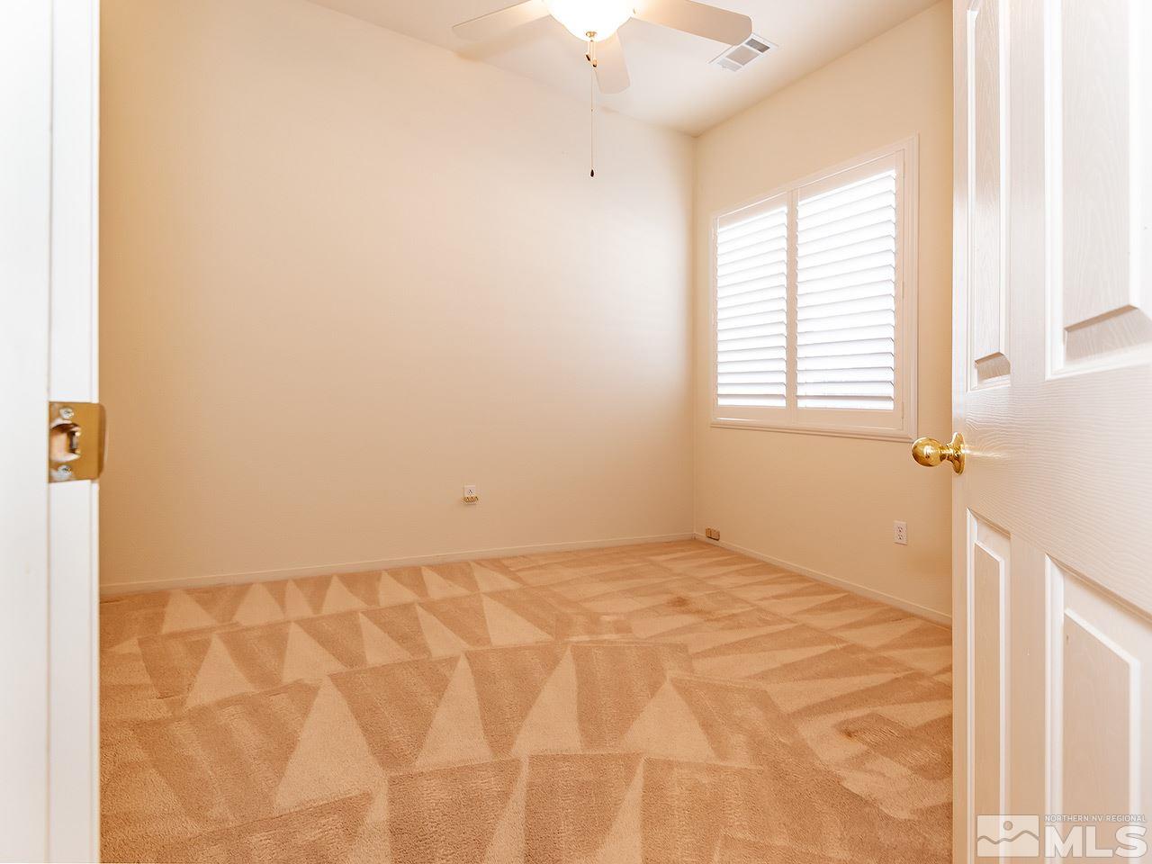 10440 Silver Rush Court Reno, NV 89521 - Photo 17 of 22 a view of an empty room with a window