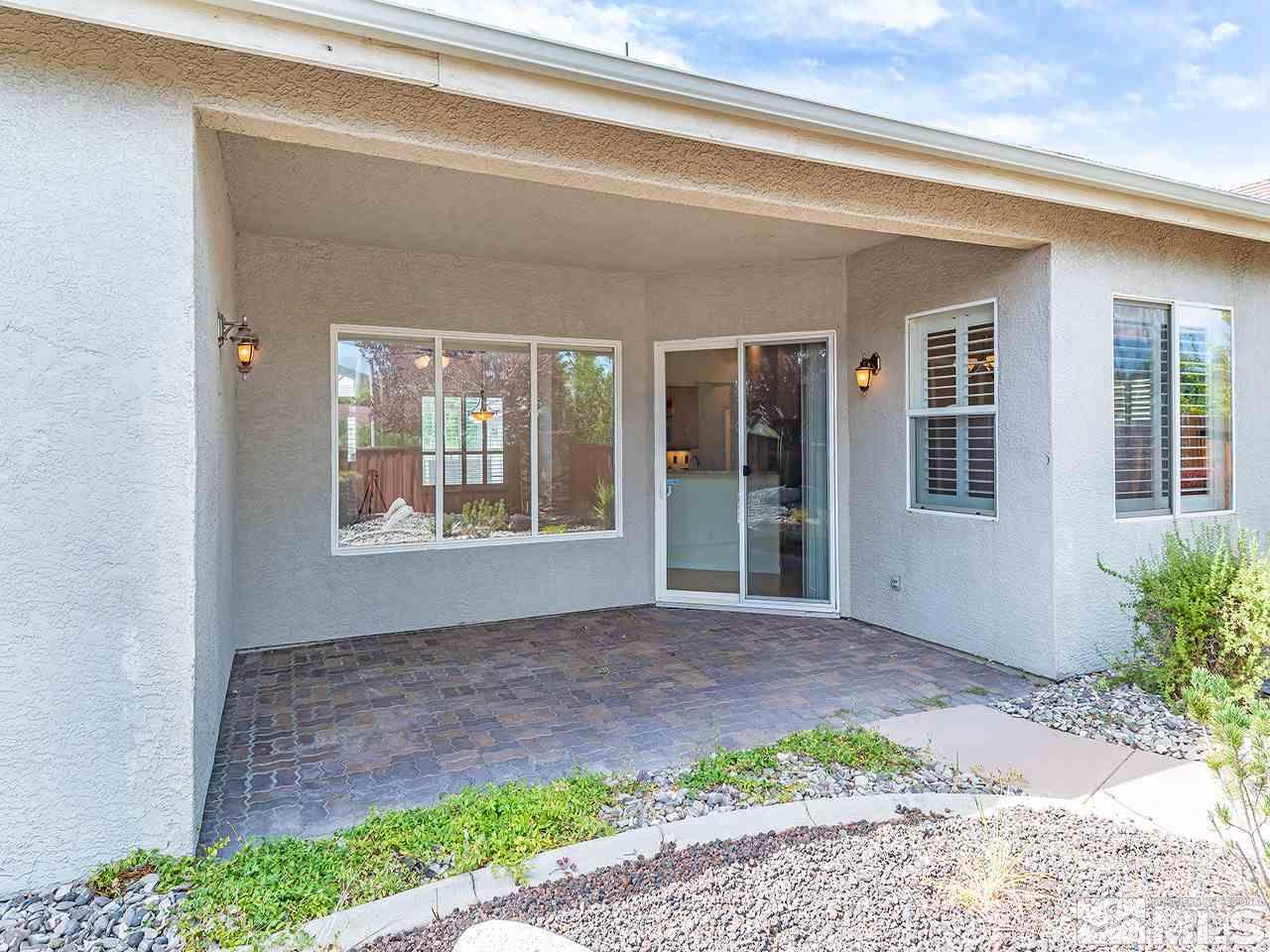 10440 Silver Rush Court Reno, NV 89521 - Photo 20 of 22 a front view of a house with a garden