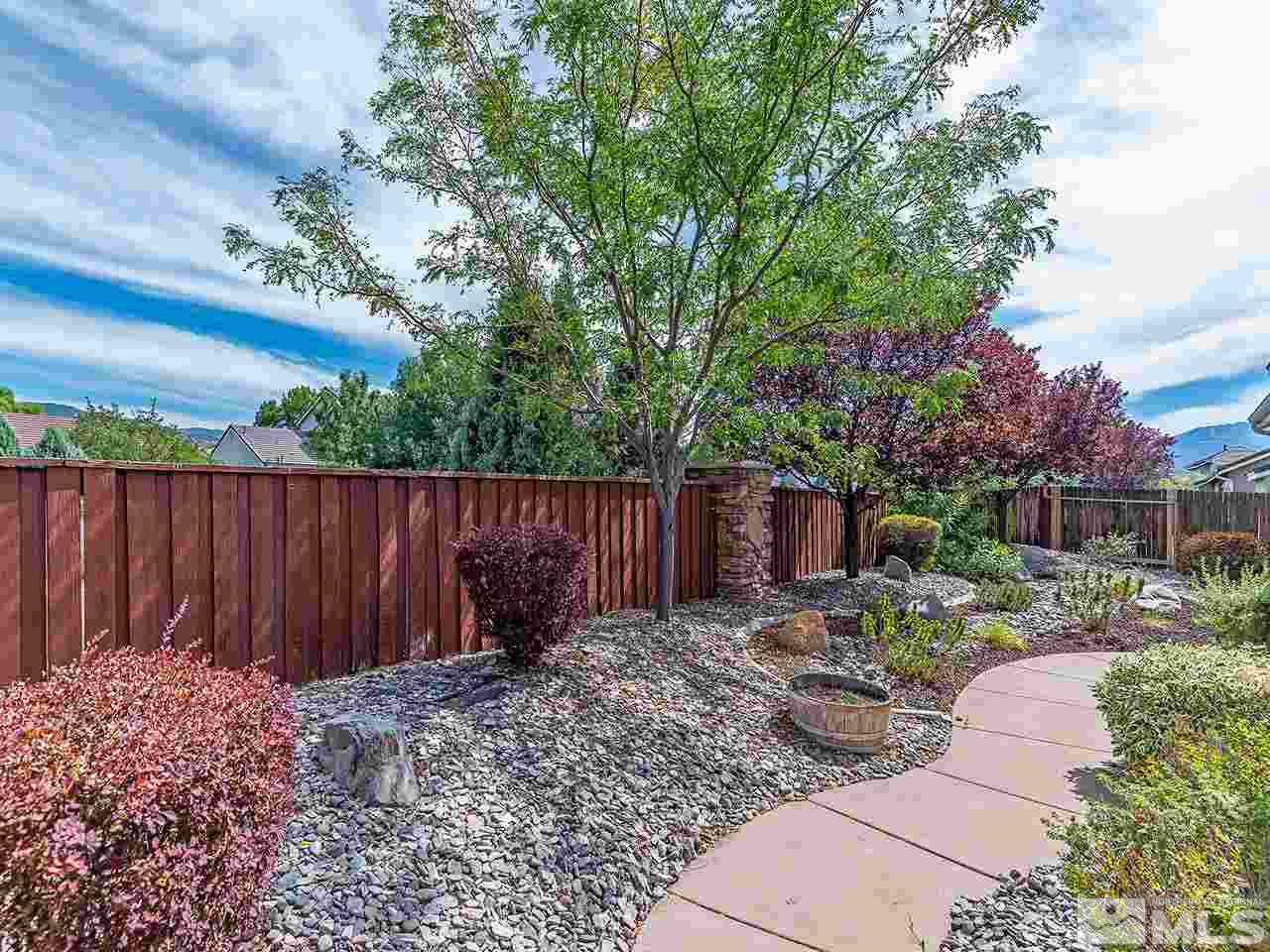 10440 Silver Rush Court Reno, NV 89521 - Photo 22 of 22 a backyard of a house with barbeque oven table and chairs