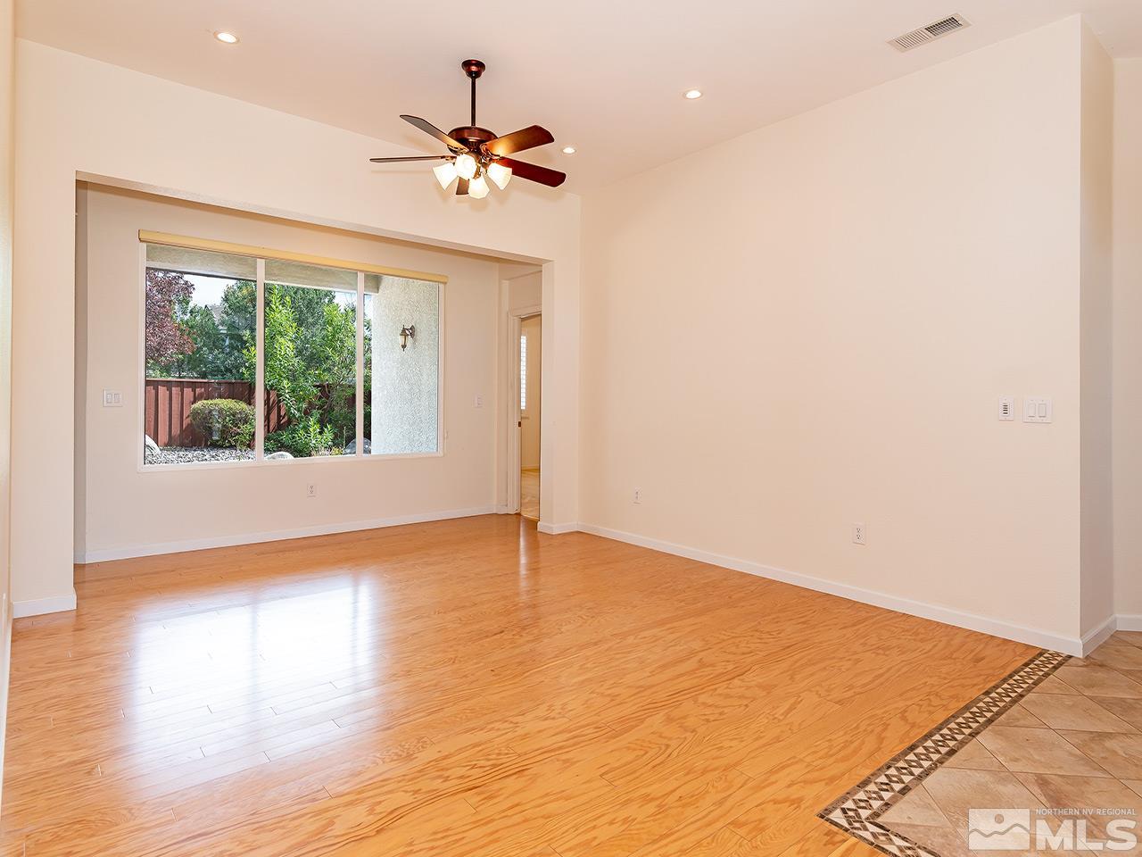 10440 Silver Rush Court Reno, NV 89521 - Photo 4 of 22 a view of an empty room with wooden floor and a window
