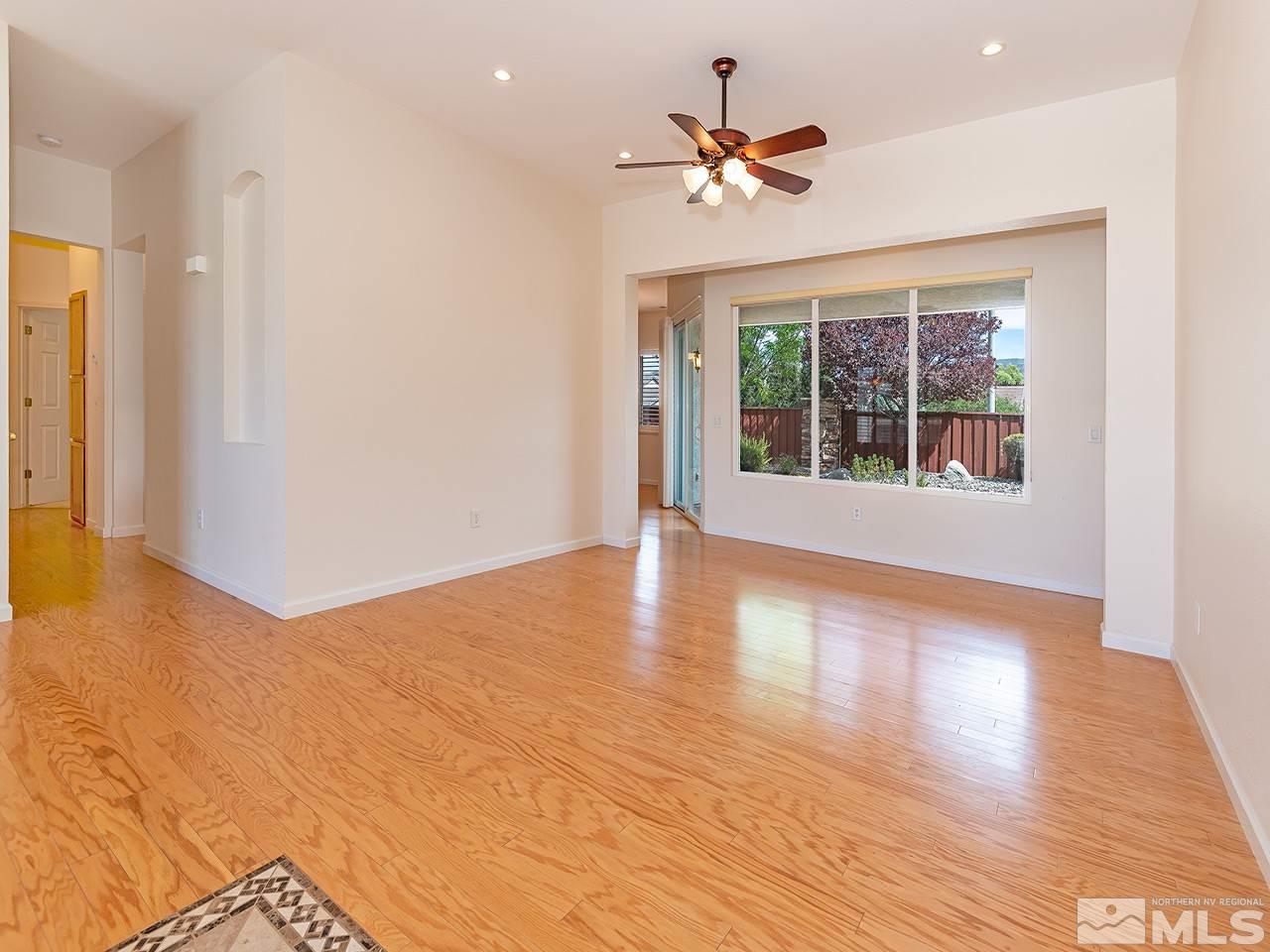 10440 Silver Rush Court Reno, NV 89521 - Photo 5 of 22 a view of an empty room with wooden floor and a window