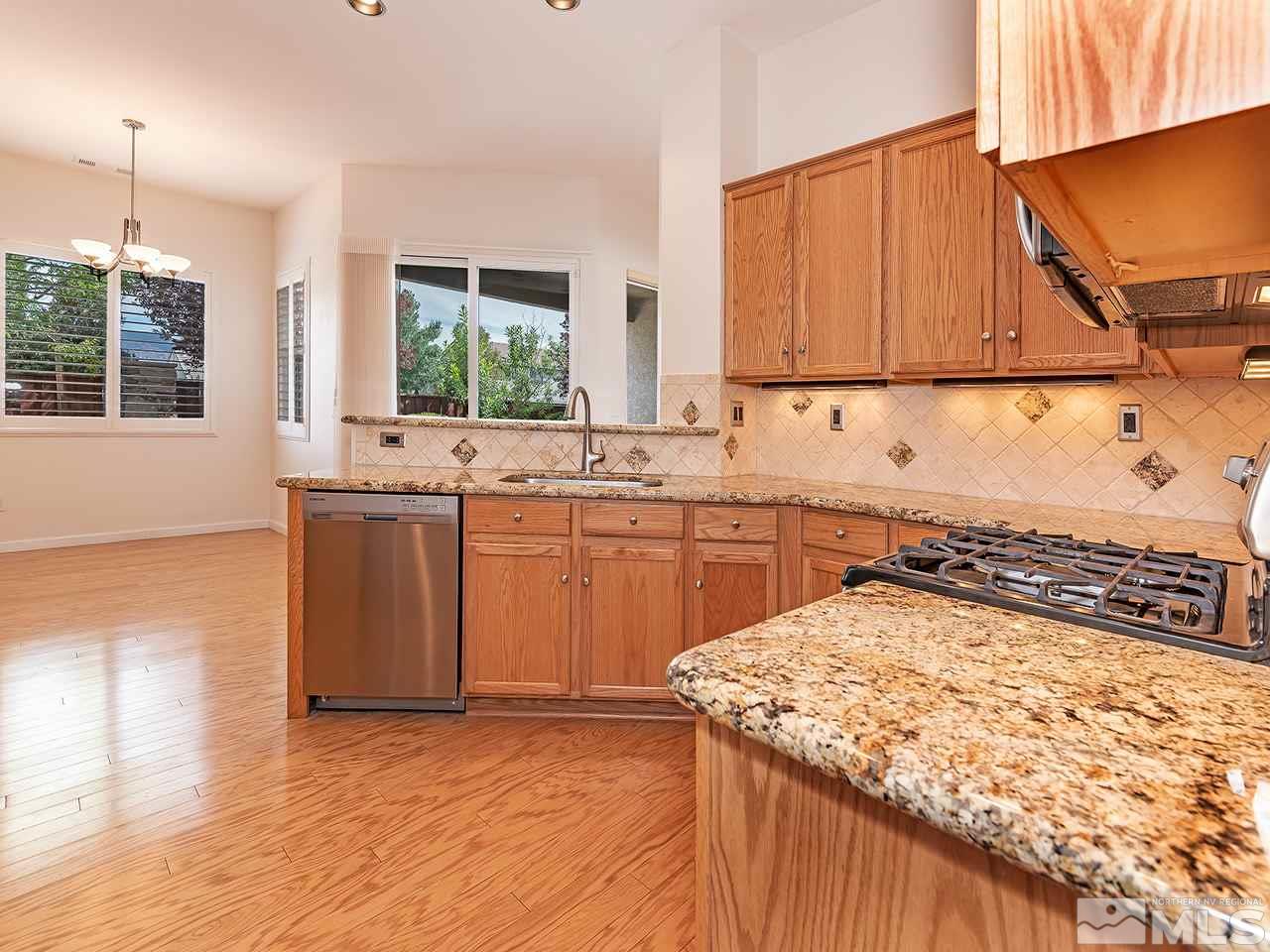 10440 Silver Rush Court Reno, NV 89521 - Photo 8 of 22 a kitchen with a sink a window and cabinets