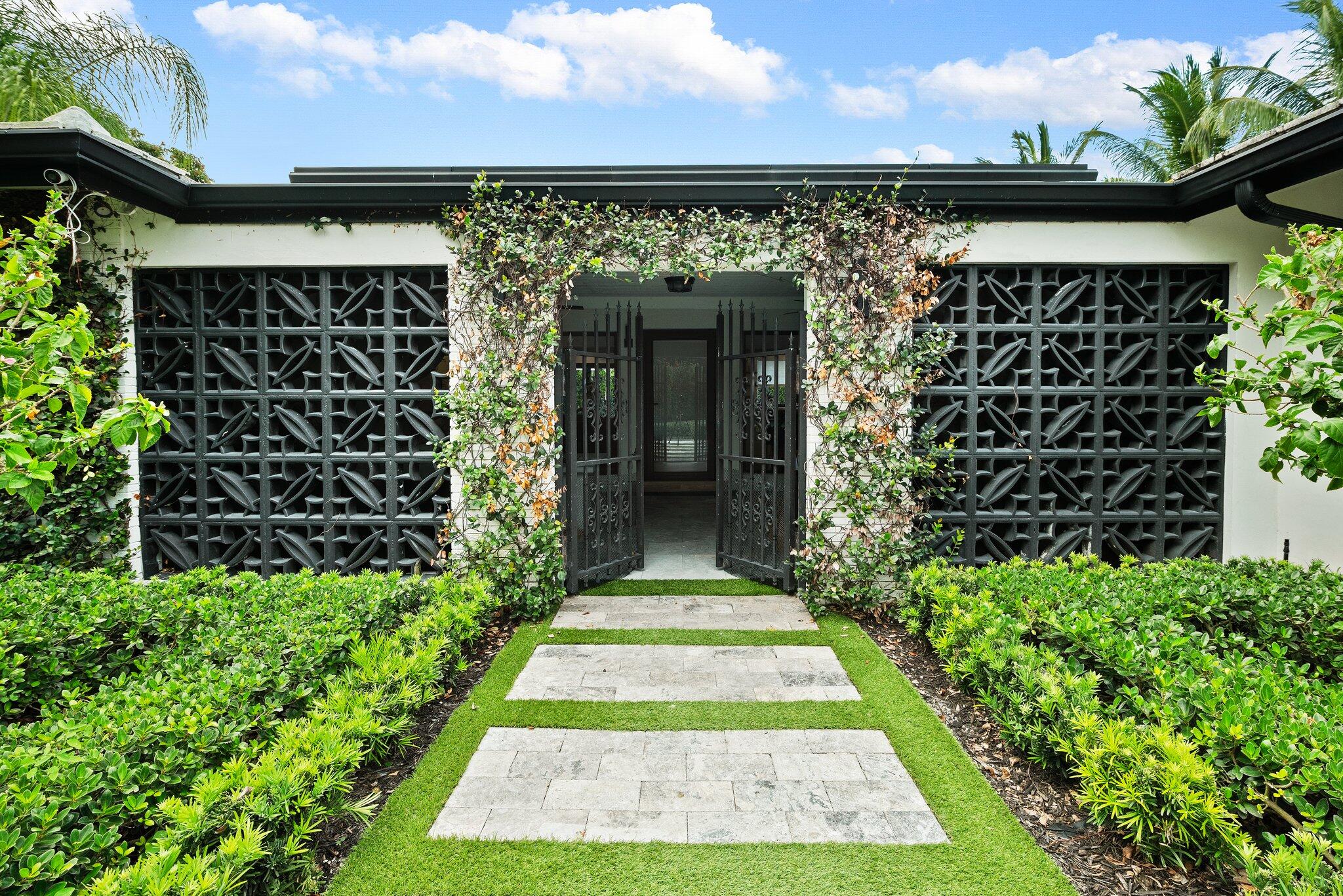 410 Southwest 7th Way Boca Raton, FL 33486 - Photo 1 of 6 a front view of a house with a yard