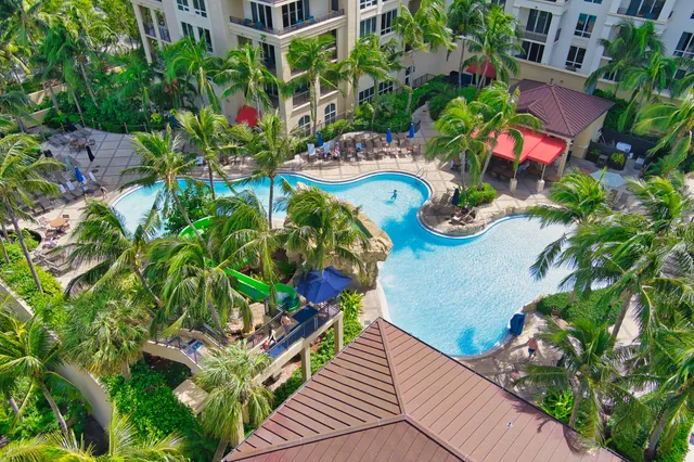 a dining hall with stainless steel appliances granite countertop a refrigerator and cabinets