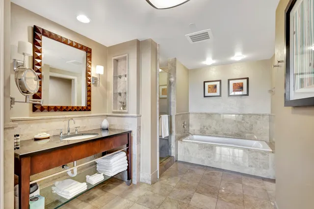 a bedroom with a large bed and a flat screen tv