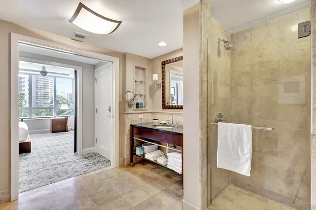 a bedroom with beds and a chandelier