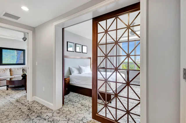 a bed room with a bed and a large window