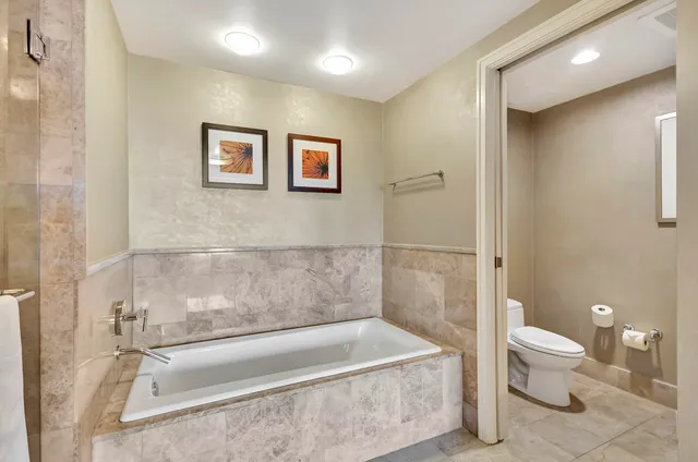 a bathroom with a sink mirror and a bathtub