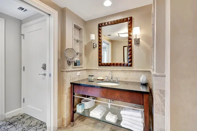 a bathroom with a double vanity sink toilet mirror and shower