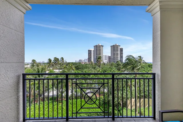 a living room with furniture and large windows