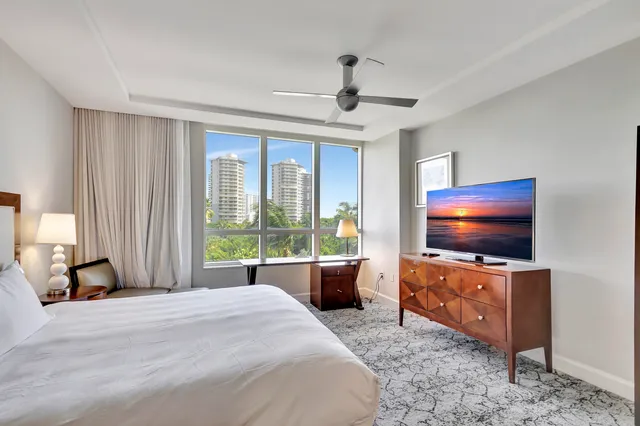 a dining room with stainless steel appliances a table chairs and a view of kitchen