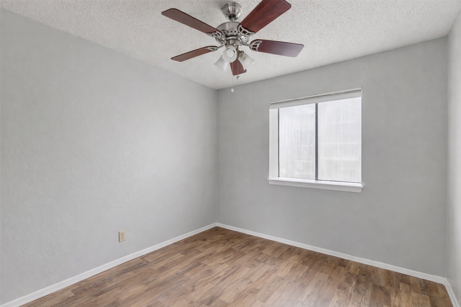 3115 Helms Street, Unit 210 Austin, TX 78705 - Photo 13 of 17 an empty room with windows and fan