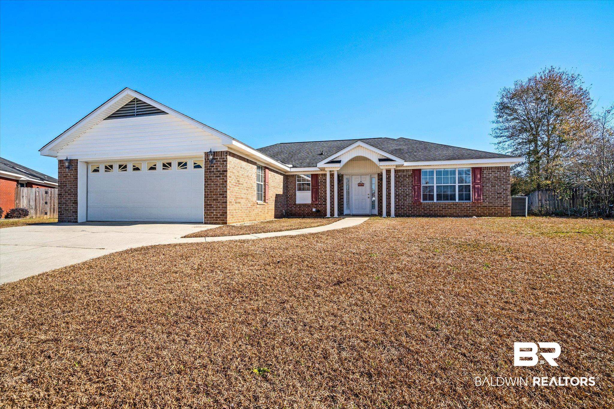 8374 Kipling Court Mobile, AL 36695 - Photo 1 of 20 Ranch-style house featuring a garage and a front lawn