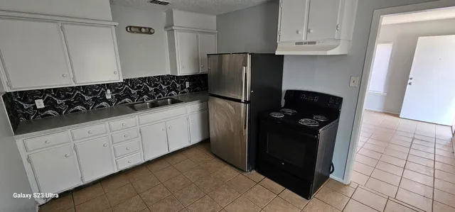 a kitchen with appliances and cabinets